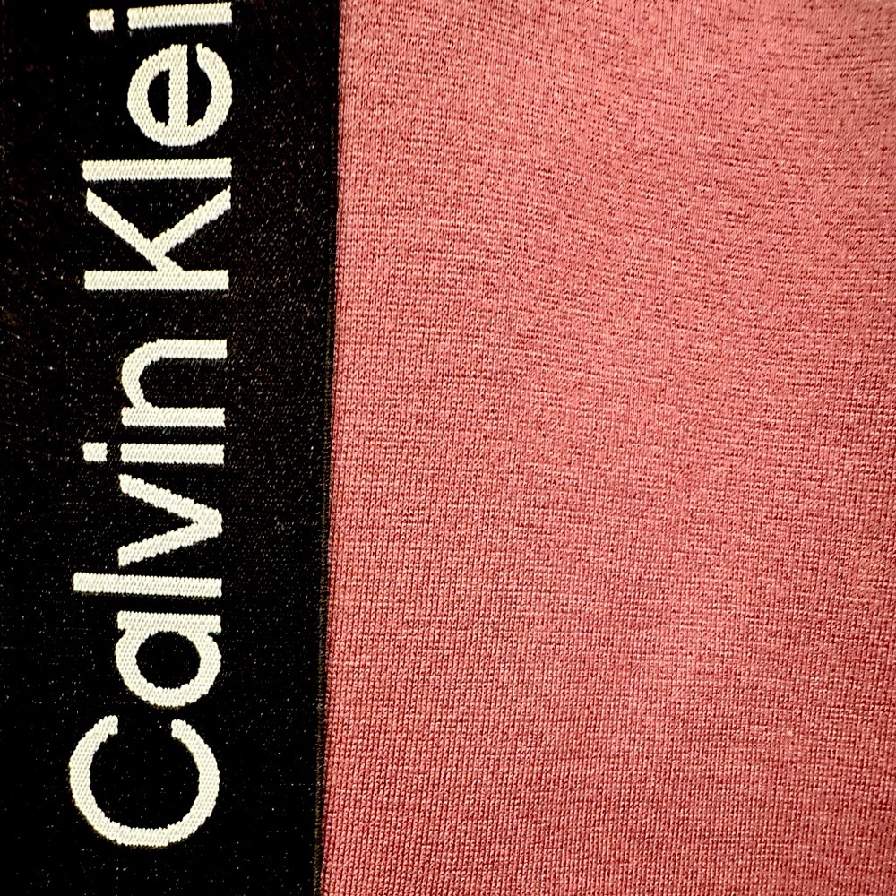 Women’s Calvin Klein size medium leggings with black stripe down sides of legs